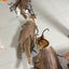 Grey cats wearing funny DIY cockroach wings and antenna costume